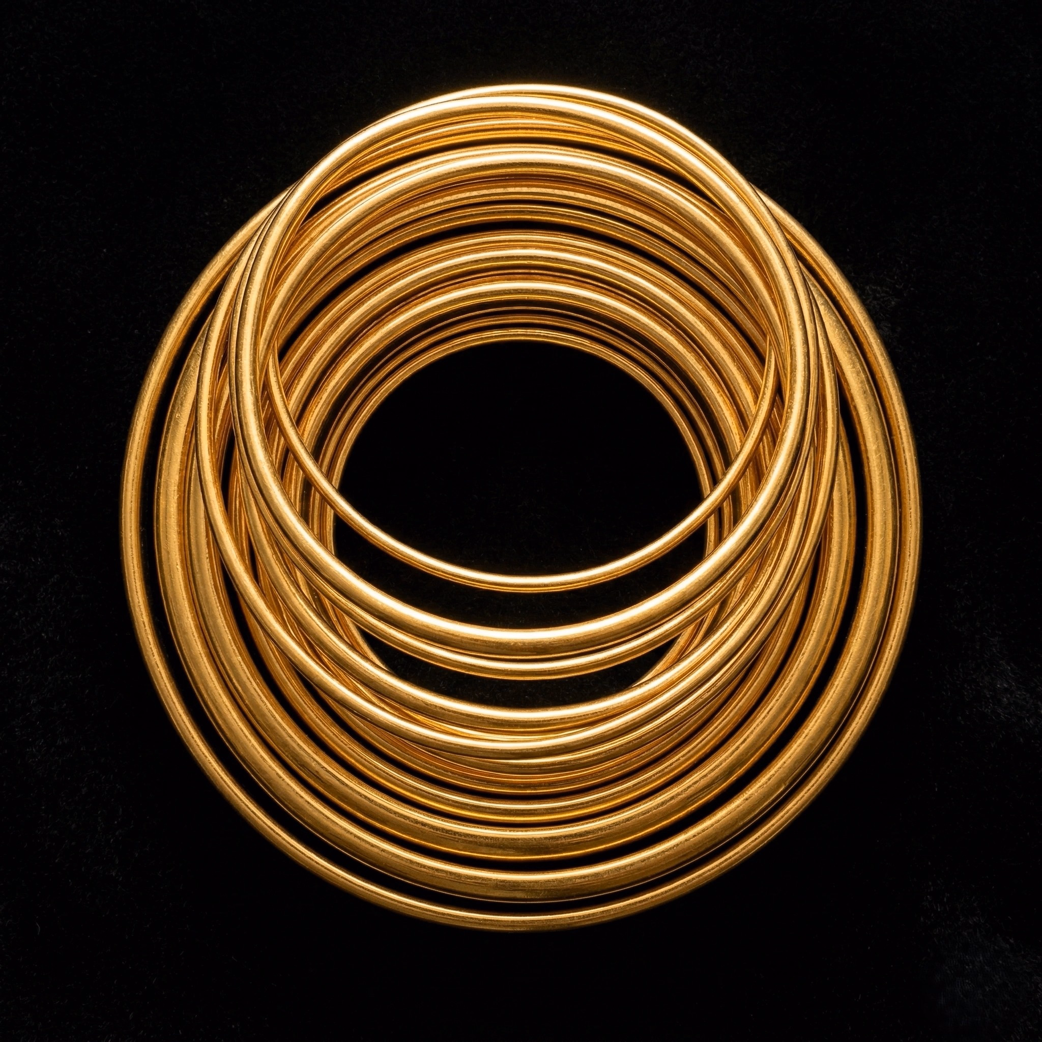 Stacked gold bangles